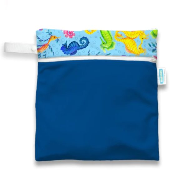 Thirsties wet dry travel bag in royal blue with a white loop handle and seahorse print at the top